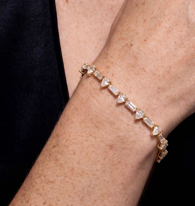 Yellow gold bracelet with pear and emerald-cut diamonds, worn