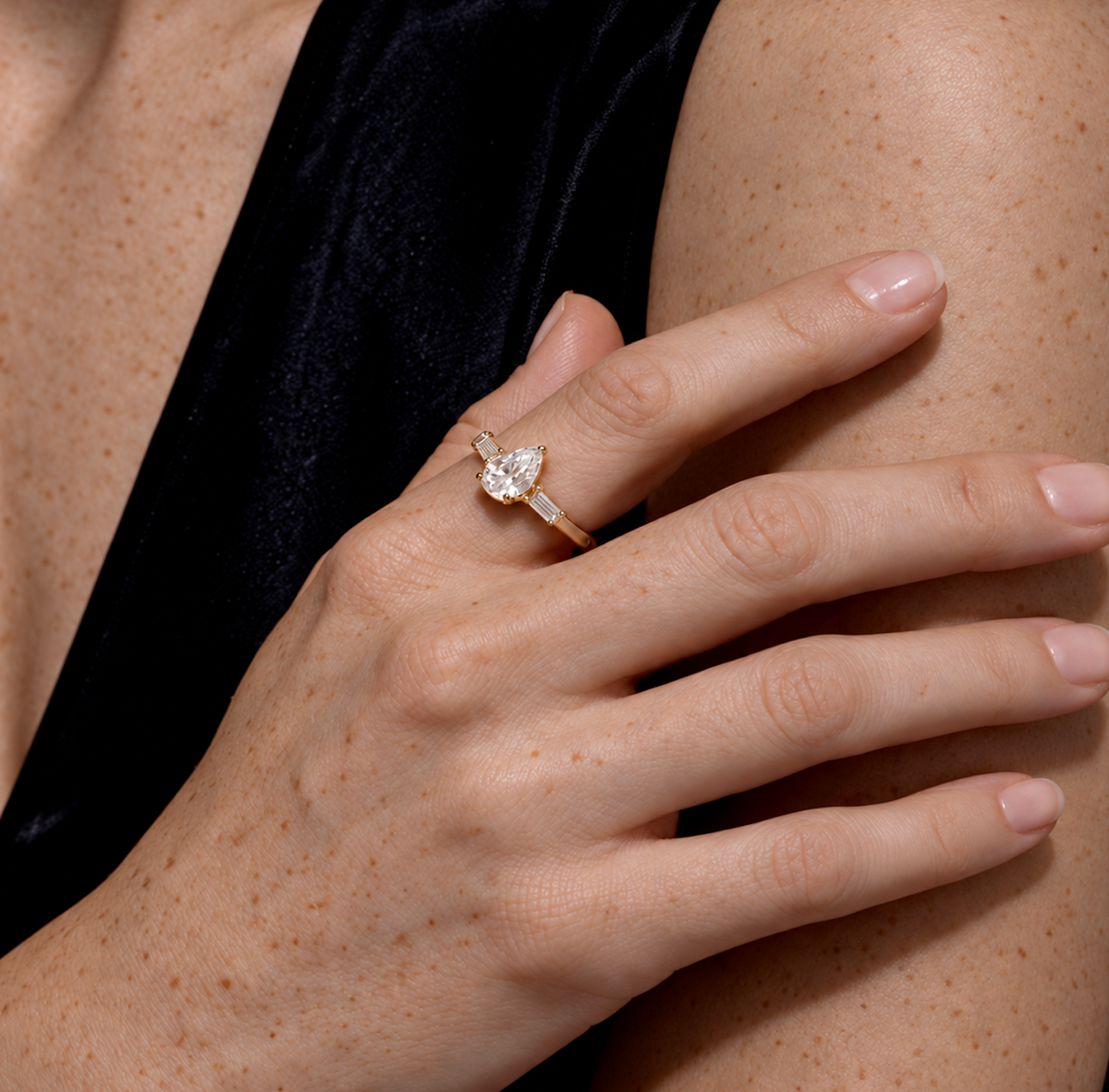 Pear diamond ring in yellow gold, worn