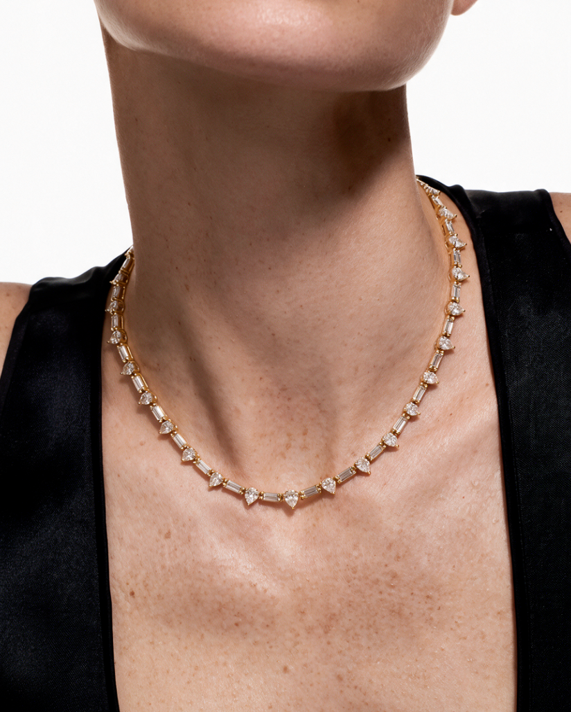 Yellow gold necklace with pear and baguette diamonds, worn